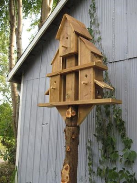 multiple birdhouses joined together in pyramid shape